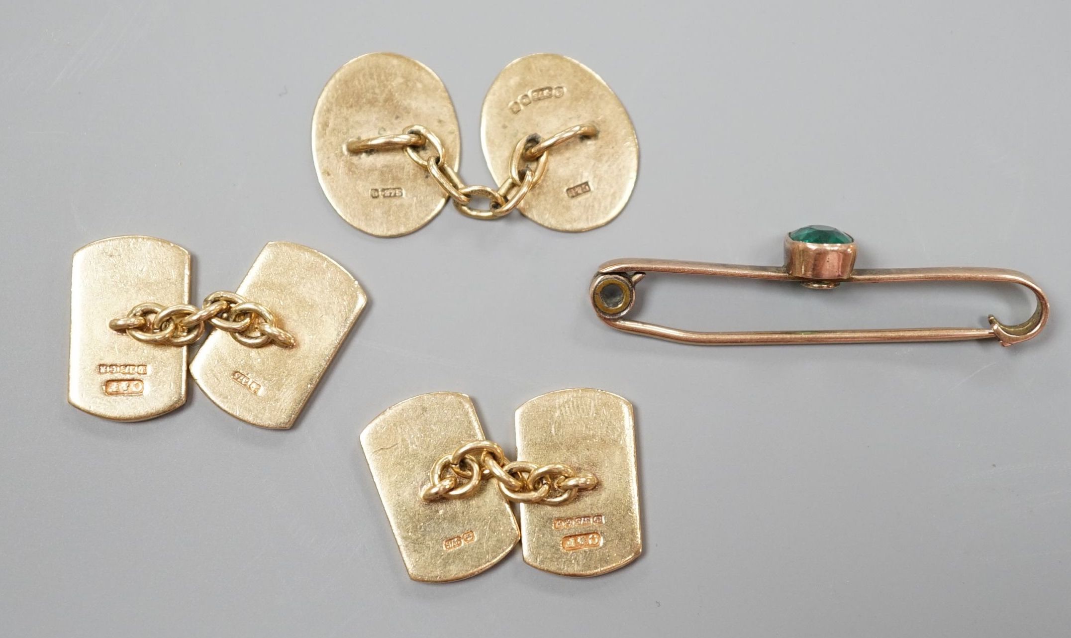 A pair of 9ct gold cufflinks, one other single 9ct gold cufflink and a 9ct and gem set bar brooch